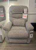 Gray recliner chair with price tags in a store setting