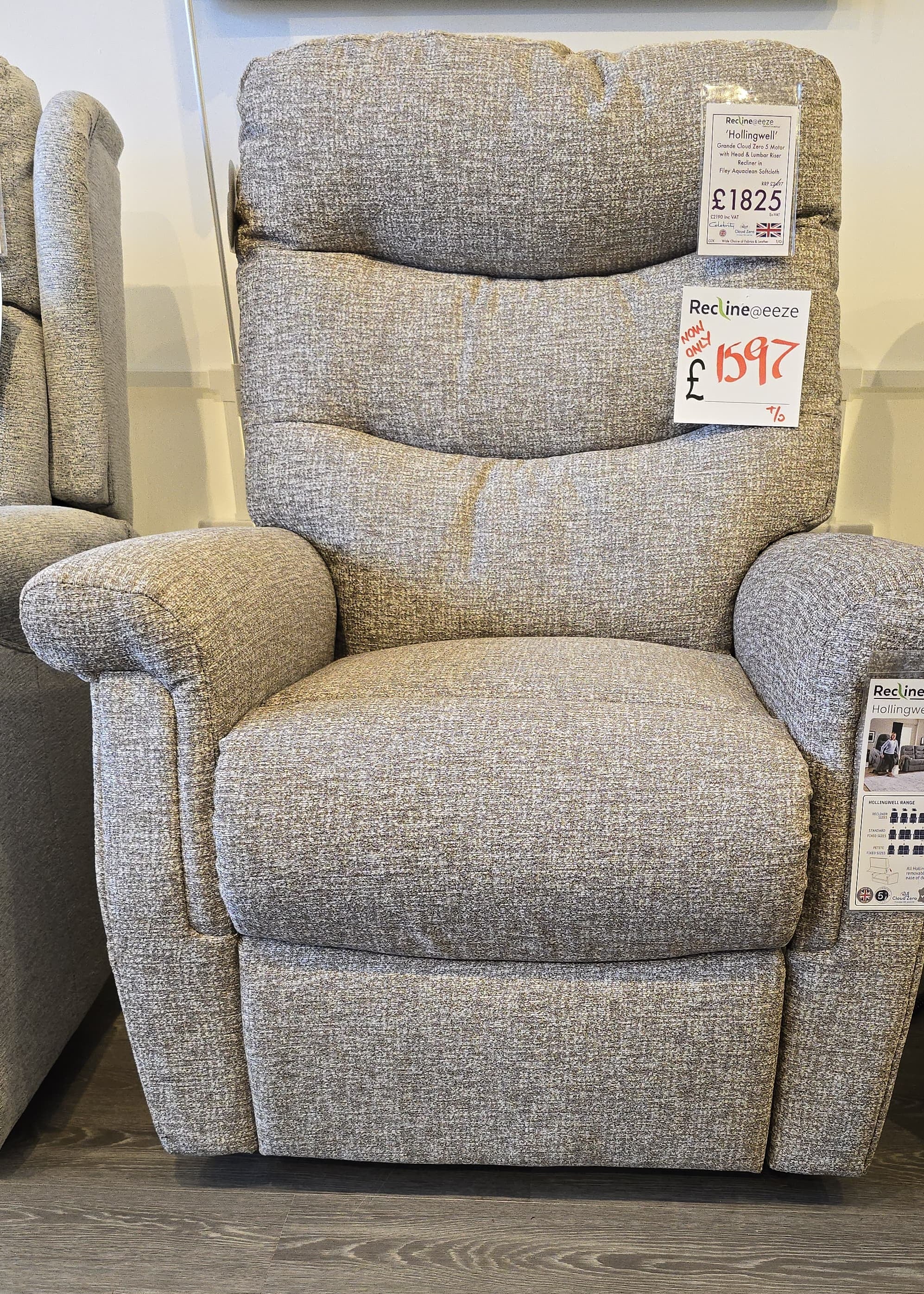 Gray recliner chair with price tags on a wooden floor